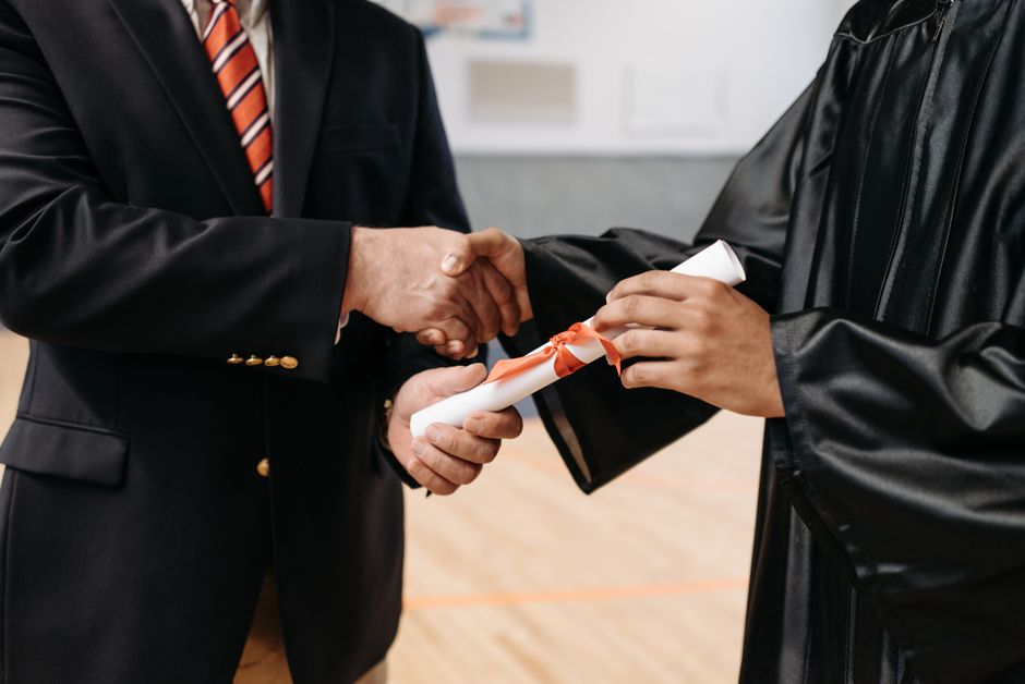A graduate receiving a scroll at the prize-giving ceremony