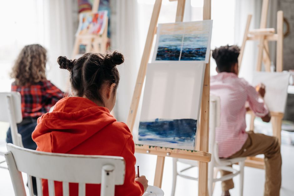 Students painting at easels in the art studio